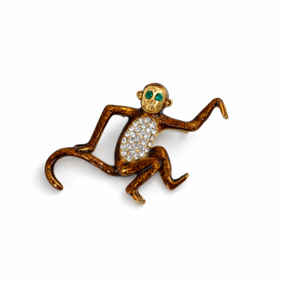 Broche em forma de macaco com pedras brilhantes e olhos verdes