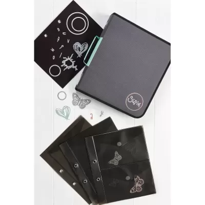 Materiais de corte Sizzix com mala cinza e preta e recortes em papel