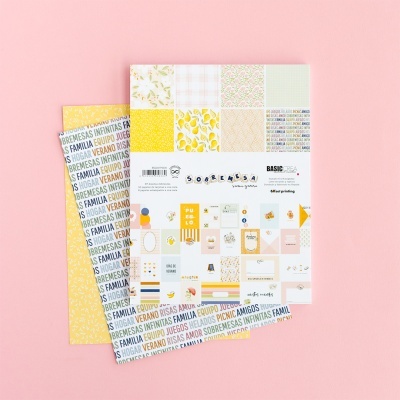 Papéis de scrapbook coloridos com padrões e texto SOBREMESA e BASIC CREA sobre fundo rosa