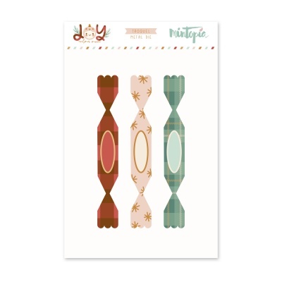 Três cortes em metal em forma de doces coloridos com padrões, em embalagem com texto JOY e mintopia