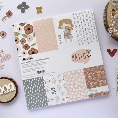 Bloco de papéis para scrapbooking com estampas florais e padrões gráficos em tons pastel e terra