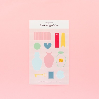 Conjunto de autocolantes coloridos variados numa folha com fundo rosa