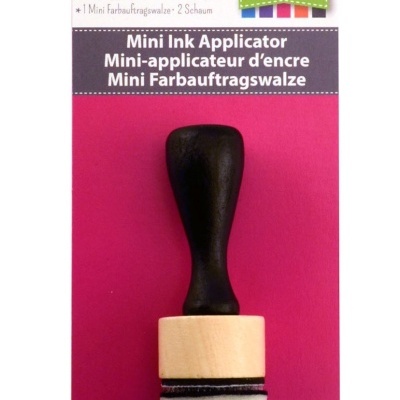 Mini aplicador de tinta com cabo preto e espuma, embalagem rosa e branca.