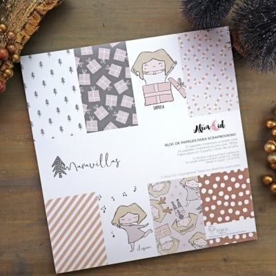 Bloco de papéis para scrapbooking com diversos padrões coloridos e desenhos infantis.