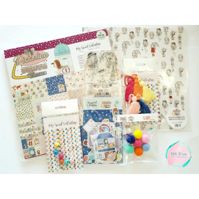 Material de scrapbooking e artesanato com papéis decorativos, pompons coloridos, fitas e adesivos com ilustrações de animais.