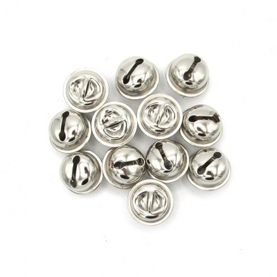 Pequenos guizos metálicos prateados num fundo branco