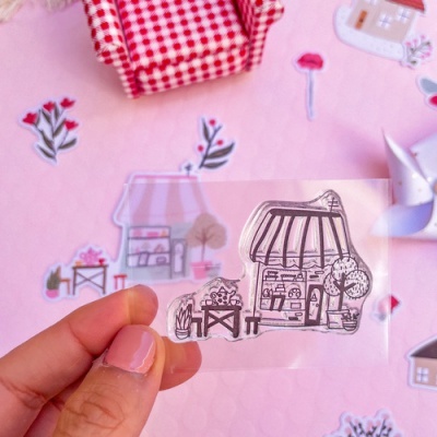 Adesivo de loja desenhada à mão, fundo rosa com flores e poltrona xadrez