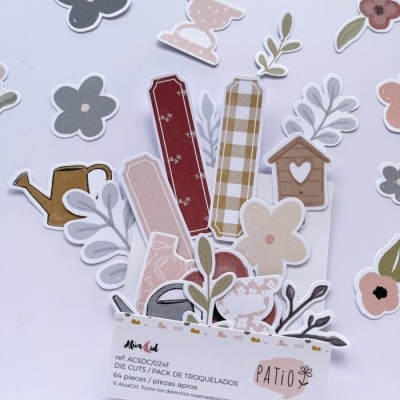 Recortes de papel de jardim em tons pastel com flores e folhagens num suporte com texto PATIO.