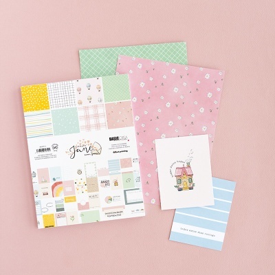 Conjunto de papelaria com padrões coloridos em fundo rosa