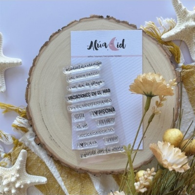 Conjunto de carimbos de silicone com frases em espanhol em suporte de madeira decorado com flores amarelas e estrelas-do-mar