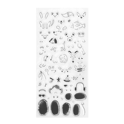 Autocolantes transparentes com desenhos a preto de rostos e partes faciais numa folha branca