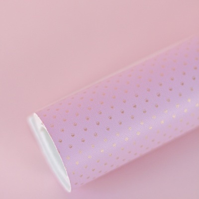 Rolo de papel decorativo lilás com pontos dourados