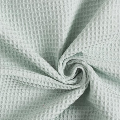 Tecido branco texturizado com padrão de colmeia