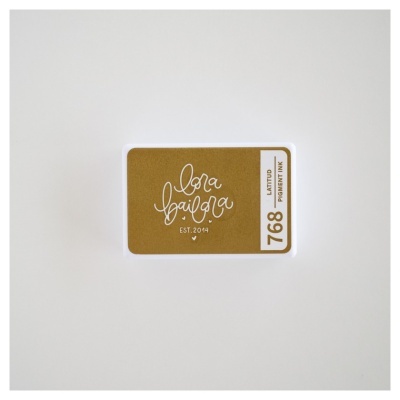 Embalagem de tinta para carimbo dourada com etiqueta branca