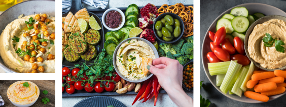 Vários pratos de hummus com legumes frescos, pão pita, azeitonas e grão-de-bico crocante