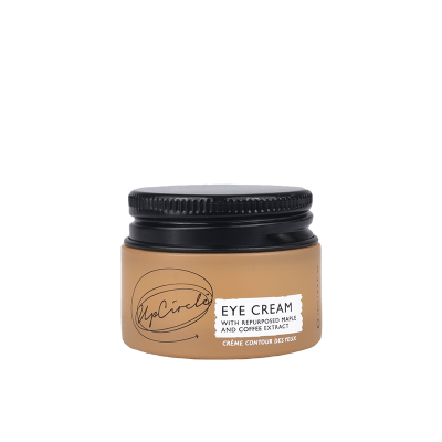 frasco de creme para olhos bege com tampa preta e etiqueta branca com texto