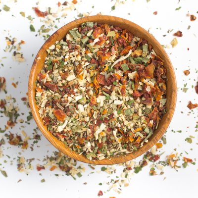 Tigela de madeira com mistura de ervas e especiarias secas coloridas