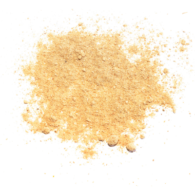 Pó amarelo claro em superfície branca com duas partículas pequenas arredondadas