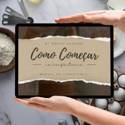 Tablet exibindo capa de manual de confeitaria, cercado por ingredientes de cozinha