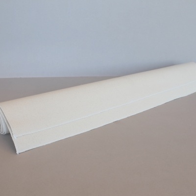 Tapete ou toalha branco enrolado sobre superfície bege