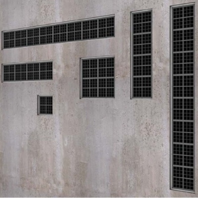 Mosaicos de ladrilhos pretos em diferentes configurações sobre parede cinzenta