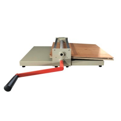 Mesa de corte manual com alavanca vermelha e superfície em madeira.