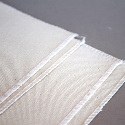 Três pedaços de tecido branco cru com textura de algodão alinhados