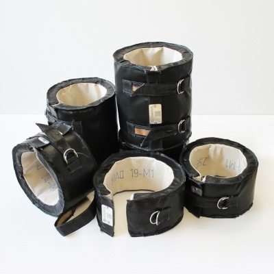 Tornozeleiras pretas com interior claro e argolas metálicas sobre superfície branca