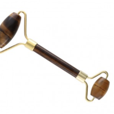 Rolo de massagem facial com pedras castanhas e estrutura dourada