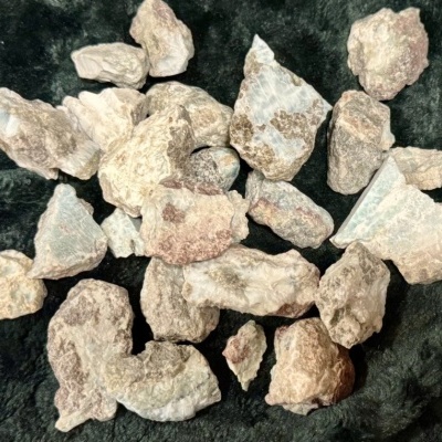 Pedras irregulares claras sobre tecido preto