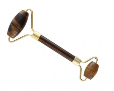 Rolo de massagem facial com pedras castanhas e estrutura dourada