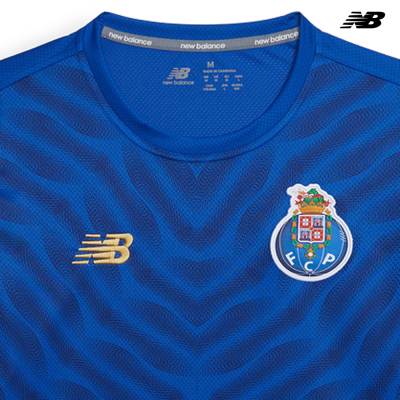 Camisola desportiva azul da New Balance com logótipo NB e emblema FC Porto