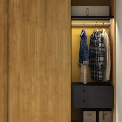 Roupeiro com portas deslizantes de madeira, interior amarelo, roupas penduradas e gavetas cinzentas