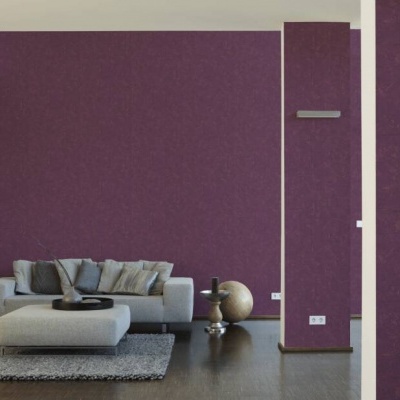 Sala moderna com parede roxa, sofá cinzento, tapete e mesa baixa branca