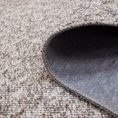 Tapete tecido bege castanho com verso cinzento dobrado mostra textura e borda costurada