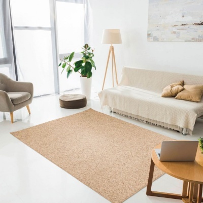 Sala de estar moderna com tapete bege, sofá com manta creme, poltrona cinza e candeeiro de pé de madeira