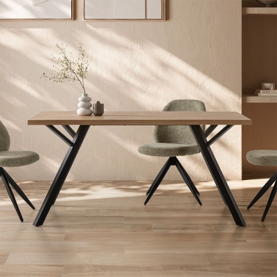 Mesa de jantar em madeira clara e metal preto com cadeiras verdes em ambiente minimalista