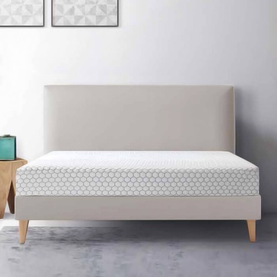 Cama de casal estofada bege com colchão branco padrão hexágonos e mesa de cabeceira de madeira