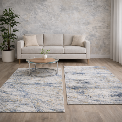 Sala de estar com sofá cinza, duas carpetes com padrão abstrato e mesa de centro redonda