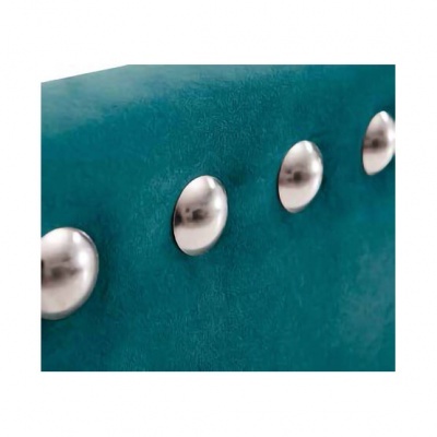 Detalhe de tecido verde-azulado com tachas metálicas prateadas