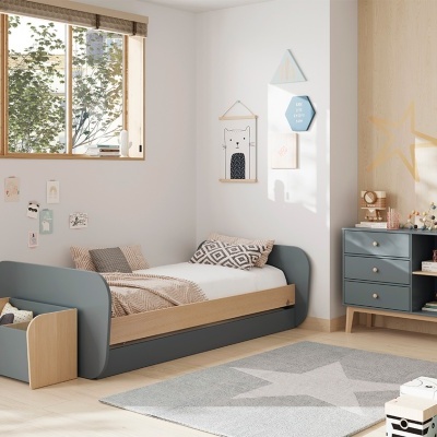 Quarto infantil com cama cinza e bege, cómoda azul, tapete cinza e decoração de parede