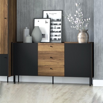 Aparador de madeira clara com portas pretas e decoração com vasos e quadros em preto e branco