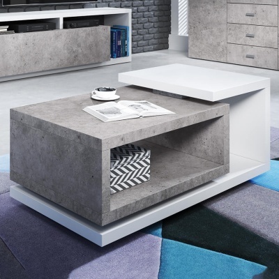 Mesa de centro cinza e branca com caixa decorativa e livro aberto