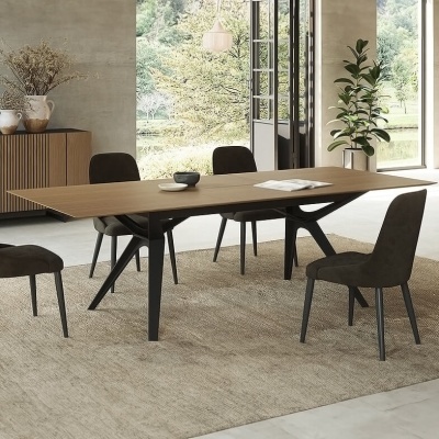 Mesa de jantar de madeira clara com cadeiras pretas numa sala moderna