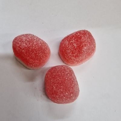 Três rebuçados vermelhos açucarados em fundo branco