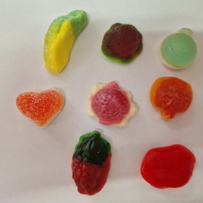 Sete gomas coloridas em várias formas sobre fundo branco