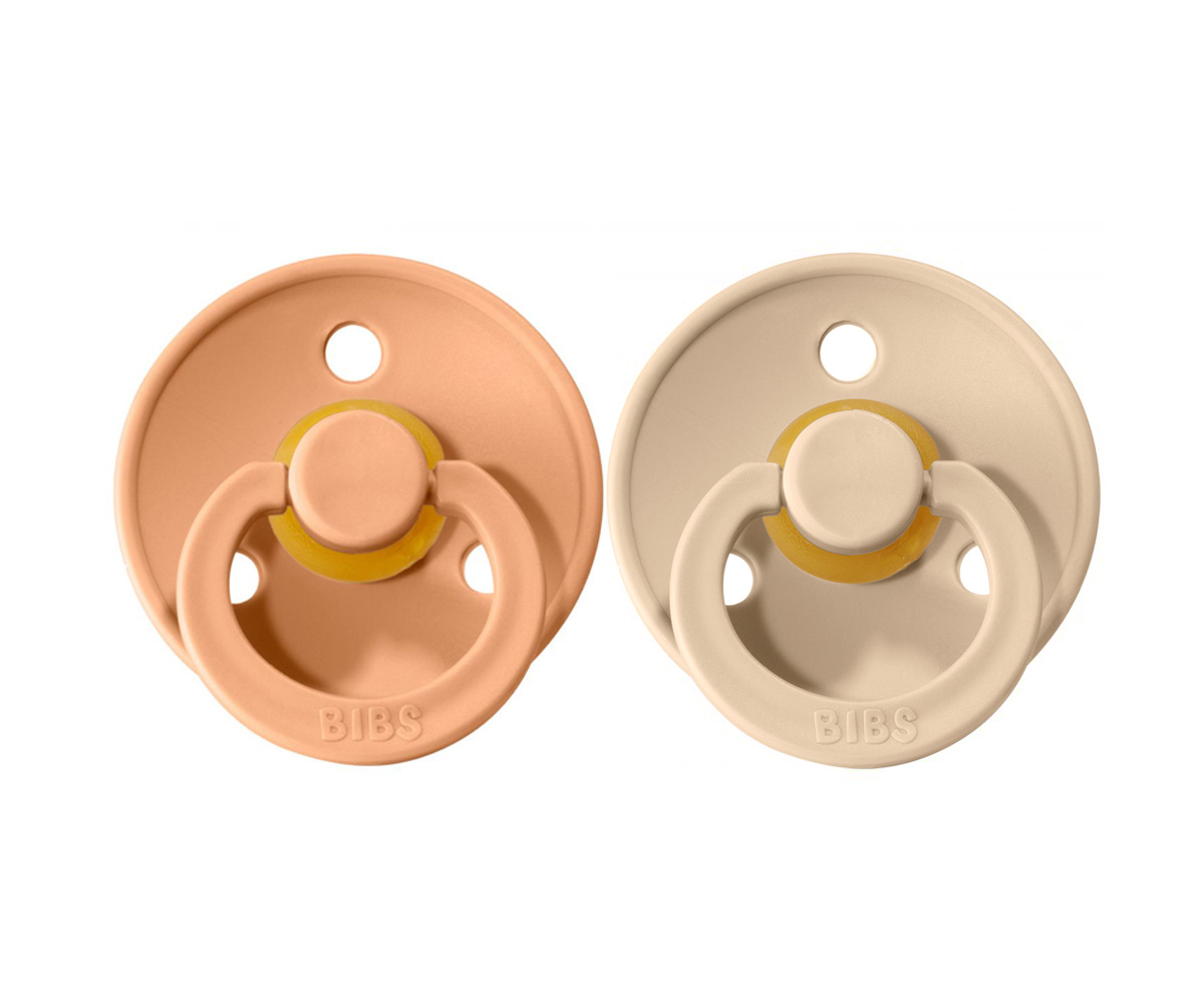 Chupeta Bibs Peach/Vanilla Dois chuchas BIBS em silicone salmão e creme com detalhes amarelos