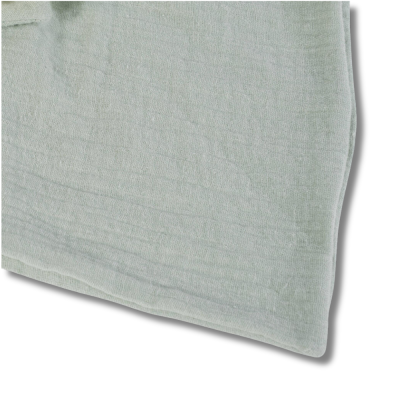 tecido verde claro com textura e costura visível