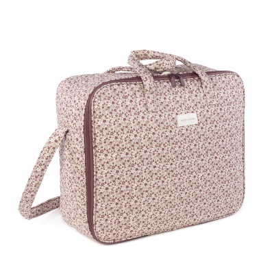 Mala têxtil com padrão floral rosa e bege com fecho.