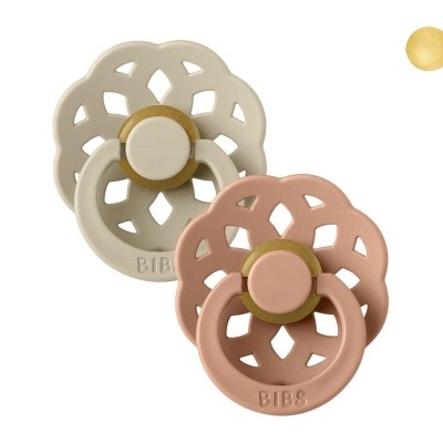 Duas chupetas BIBS em tons bege e rosa com design florido recortado